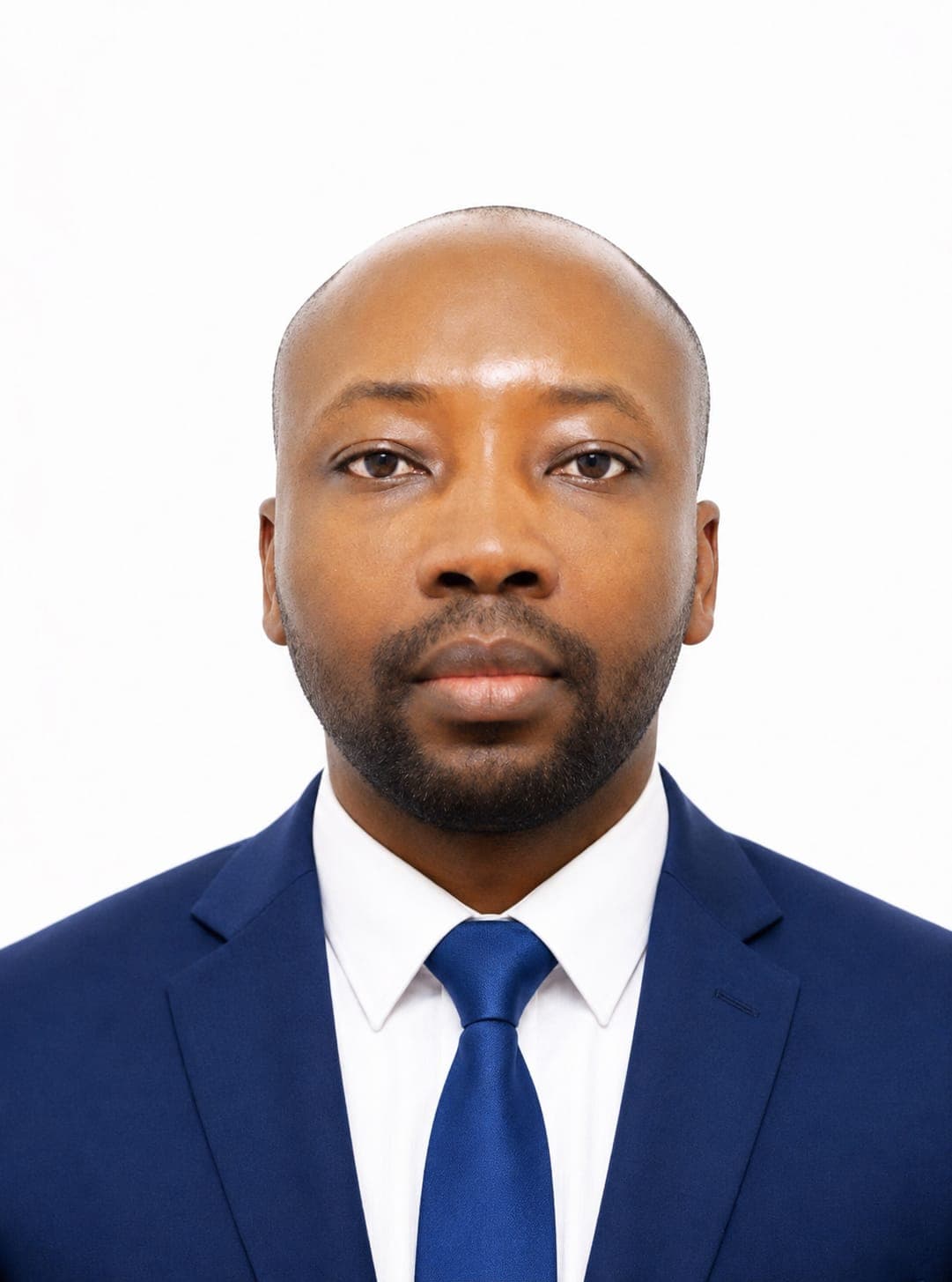 Professional headshot of a Black man with a beard, wearing a blue suit and tie.